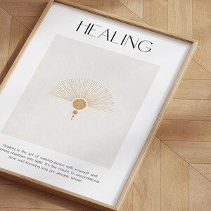 May include: A beige poster with a gold sunburst design and the word "HEALING" in black text. The poster also includes a quote about healing and peace.