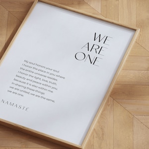May include: A framed print with a white background and black text. The text reads "WE ARE ONE" in large letters at the top of the print. Below the large text is a poem that reads "My soul honors your soul. I honor the place in you where the entire universe resides. I honor the light, love, truth, beauty and peace within you, because it is also within me. In sharing these things we are united, we are the same, we are one. NAMAST&Eacute;"