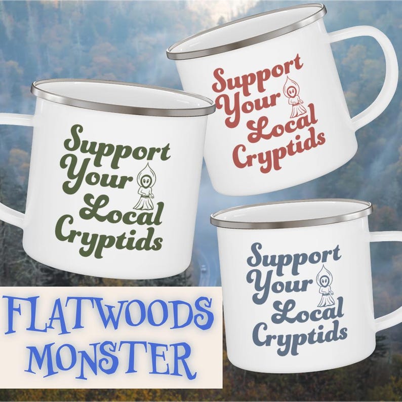 May include: White enamel mugs with silver rims and handles. Each mug features the text "Support Your Local Cryptids" in different colors, along with a small cryptid illustration. The phrase "Flatwoods Monster" is also visible.