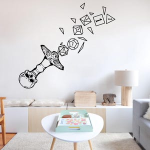 May include: Black and white wall decal of a skull with a sword piercing through it. The sword is breaking apart into dice with different numbers on them.