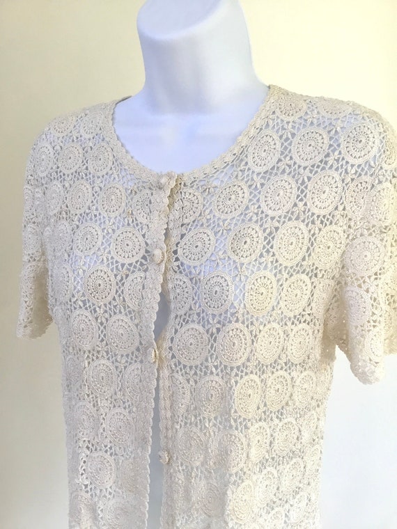 Hand crochet short sleeve button front top. Croche