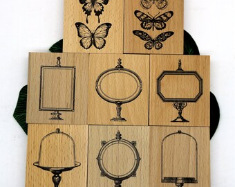 May include: Set of nine wooden stamps featuring various designs, including butterflies, frames, and cake stands. The stamps are all rectangular and have a natural wood finish.