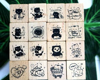 May include: Set of 16 wooden stamps featuring black and white illustrations of cats in various poses and with different sayings. The sayings include "Happy", "Take Easy", "Happy Time", "Coffee", and "Thank You".
