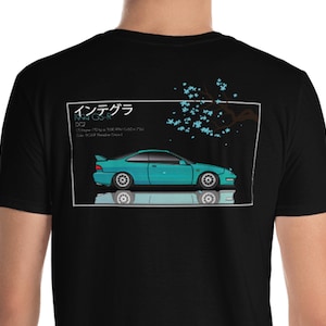 May include: Black t-shirt with a graphic of a teal Honda Integra Type R with the text "インテグラ 1994 GS-R DC2" and a cherry blossom branch in the background.