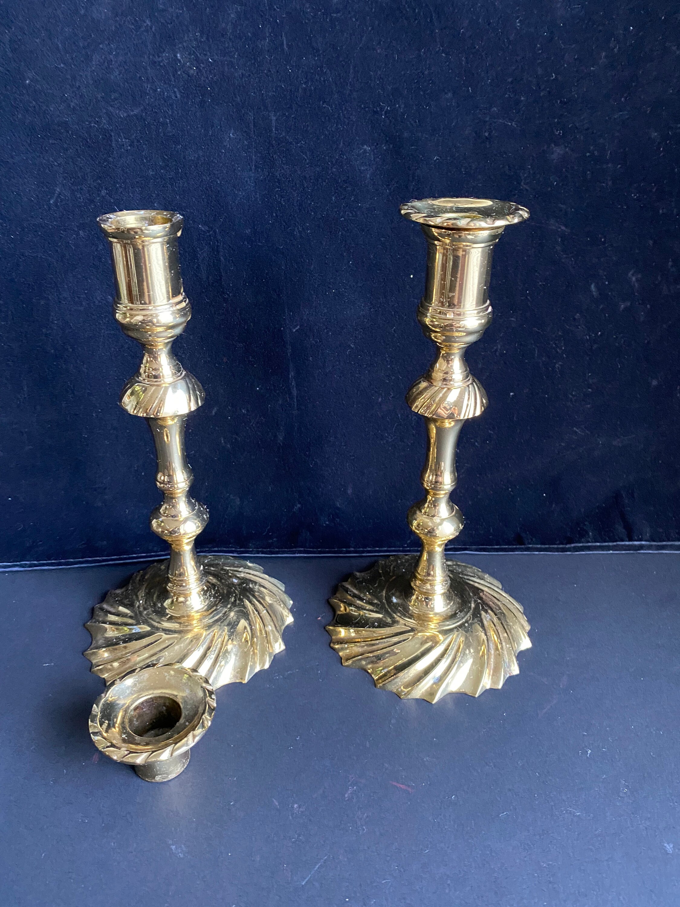 Lot - Four antique brass lighting objects, including a fluid lamp, gimbal  candle holder, square tray chamber stick and push-up round foot