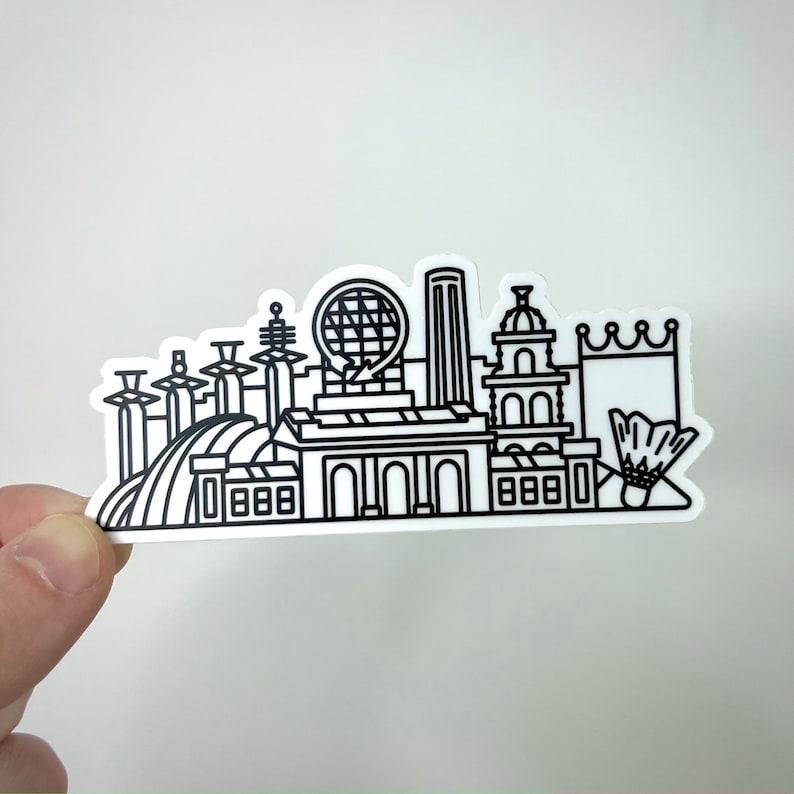 K&ouml;nnte beinhalten: Schwarz-wei&szlig;er Linienkunstaufkleber eines Stadtbildes mit verschiedenen Geb&auml;uden, darunter ein Riesenrad, ein Schloss und ein Badminton-Federball.