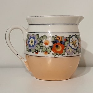 Creamer lusterware white porcelain with black & multi-color floral band/ trim, iridescent tan bottom band. Czecho-Slovakia. Vintage 1950s. image 1