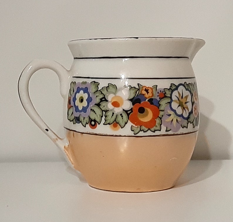 Creamer lusterware white porcelain with black & multi-color floral band/ trim, iridescent tan bottom band. Czecho-Slovakia. Vintage 1950s. image 1