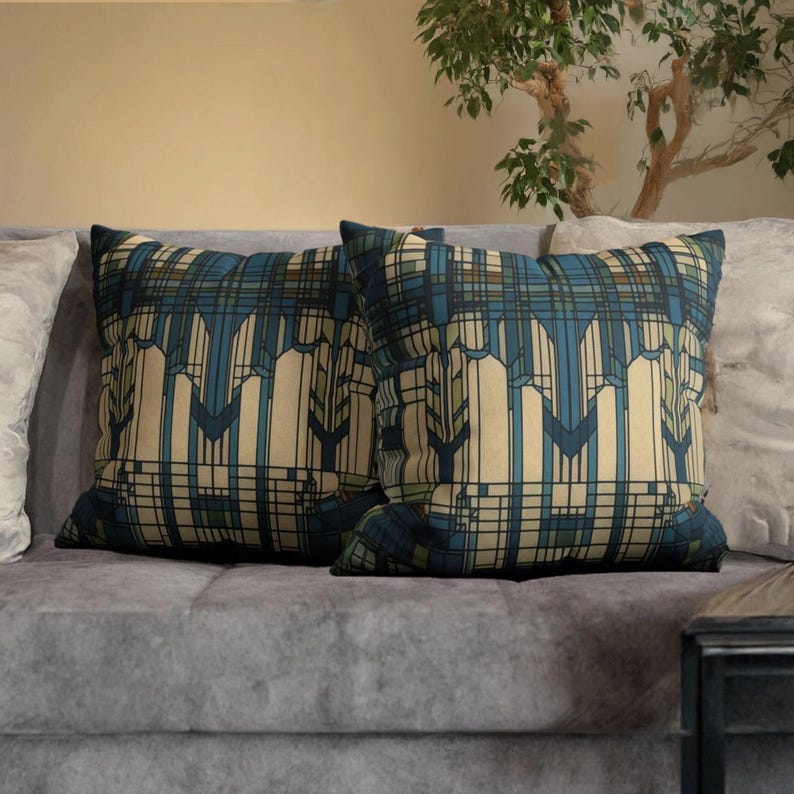 May include: Two square throw cushions featuring a geometric pattern in shades of blue, cream, and dark green. The design consists of vertical lines and angular shapes that create a structured, repeating motif across the fabric surface of both cushions.
