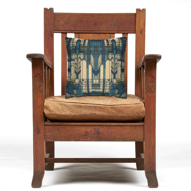 May include: A square throw cushion featuring a geometric pattern in shades of blue, cream, and brown. The design consists of intersecting vertical and horizontal lines and rectangular shapes, creating a structured, symmetrical, and repeating grid-like motif.