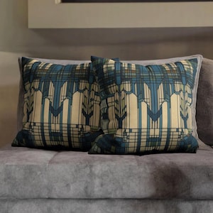 May include: Two square throw cushions featuring a geometric pattern with vertical lines and intersecting horizontal bars in shades of cream, dark blue, and muted green. The design creates a structured, architectural grid effect across the fabric.