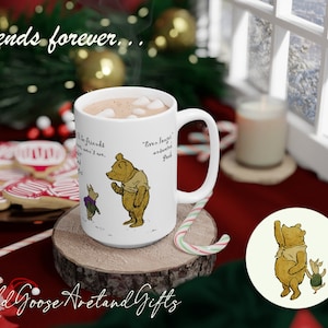 May include: A white ceramic mug with a Winnie the Pooh design, filled with hot chocolate and marshmallows. The mug is on a wooden coaster, with candy canes and cookies nearby. The text "friends forever" is above the mug.