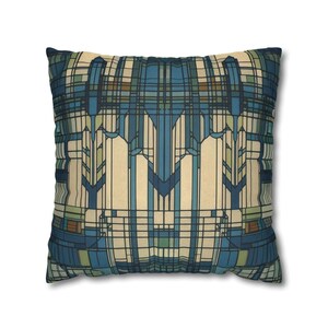 May include: A square throw pillow featuring a geometric pattern of intersecting lines and rectangles in shades of deep blue, light blue, cream, and muted green. The design creates a symmetrical, grid-like composition across the entire surface.