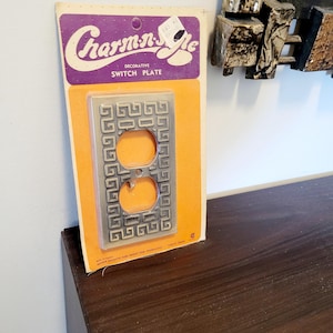 May include: A handmade wooden sign displaying the word "Welcome" in a whimsical font. The white-painted sign has a distressed finish and a small heart detail. Suitable for indoor or outdoor display.