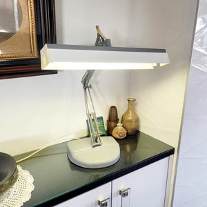 May include: A rustic wooden sign with the words "Welcome to our home" in white lettering. The sign has a distressed finish and a simple, inviting design, suitable for a front porch or entryway.