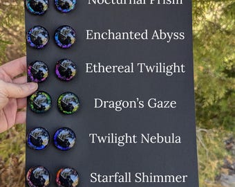 May include: Six pairs of colorful glass eyes for crafts, with names like "Nocturnal Prism", "Enchanted Abyss", and "Starfall Shimmer".