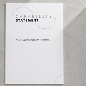 May include: A white document with black text that reads CAPABILITY STATEMENT and Present your business with confidence. The design features thin black line art of two intersecting semi-circles positioned behind the main title text.