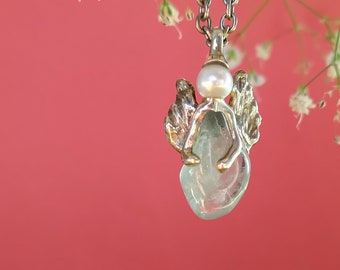 Wonderful guardian angel for everyday life. An aquamarine and a freshwater pearl set in silver.