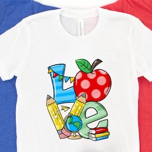 May include: White t-shirt with a colorful graphic design that says "LOVE" with a red apple, pencils, a globe, and books.