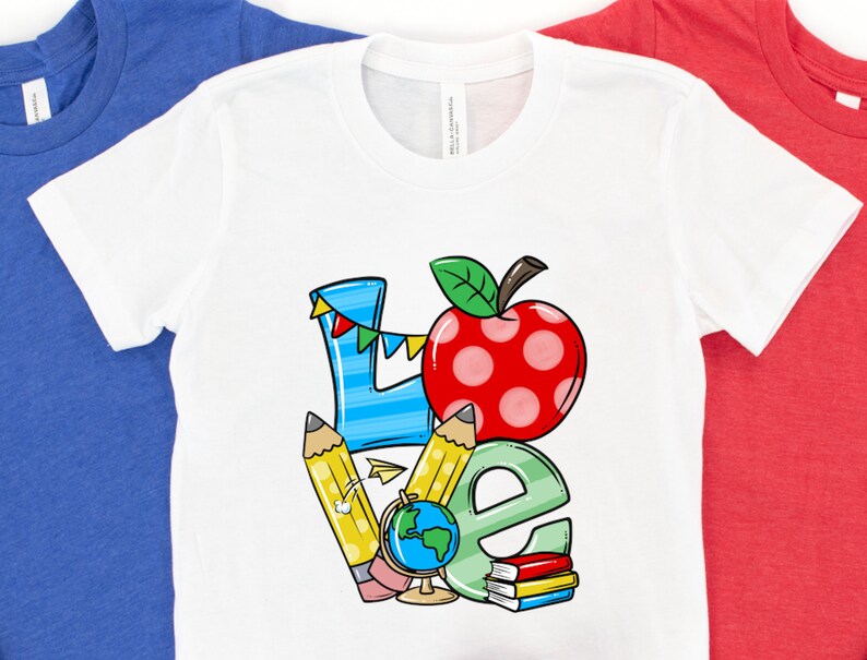 May include: White t-shirt with a colorful graphic design that says "LOVE" with a red apple, pencils, a globe, and books.