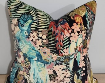 May include: A black velvet pillow with a tropical print featuring colorful birds, flowers, and leaves.