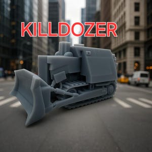 May include: A gray, miniature bulldozer model with the word "KILLDOZER" printed in red letters on the front. The model is sitting on a gray surface.