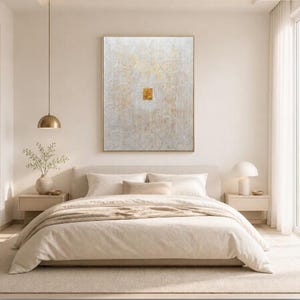 May include: A large rectangular wall art piece featuring a textured white surface with intricate, swirling patterns and subtle gold leaf accents. A small, solid gold square is positioned in the centre of the composition, creating a focal point.