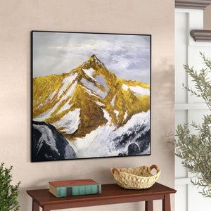 May include: Abstract painting of a snow-capped mountain range with a golden peak. The painting is done in shades of white, grey, and gold.