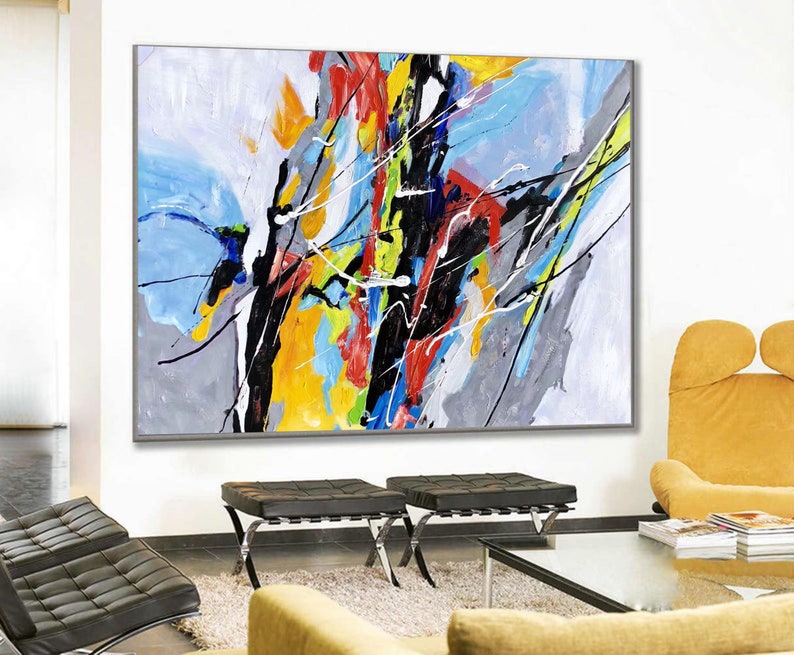 May include: Abstract painting with bold strokes of black, yellow, blue, red, and green on a white background. The painting is framed in a gray frame.
