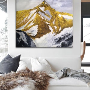 May include: A painting of a snow-capped mountain peak with a golden hue. The mountain is painted in a textured style with visible brushstrokes. The background is a light blue sky with white clouds.
