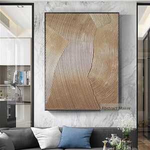 Puede incluir: Impresi&oacute;n de arte abstracto con un esquema de color dorado y blanco. La impresi&oacute;n presenta un dise&ntilde;o texturizado y en capas con l&iacute;neas curvas y formas geom&eacute;tricas.