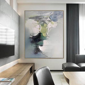 May include: Abstract painting with shades of green, blue, and white. The painting is on a canvas and is framed in a gold frame. The painting is hanging on a wall in a living room.