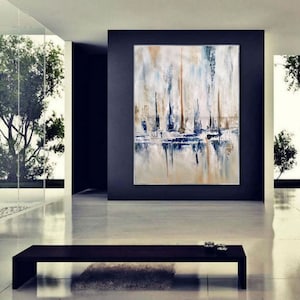 May include: Abstract oil painting on canvas featuring a coastal scene with vertical brushstrokes in white, blue, and tan. The artwork is displayed in a modern, minimalist interior with a dark accent wall and a black bench.