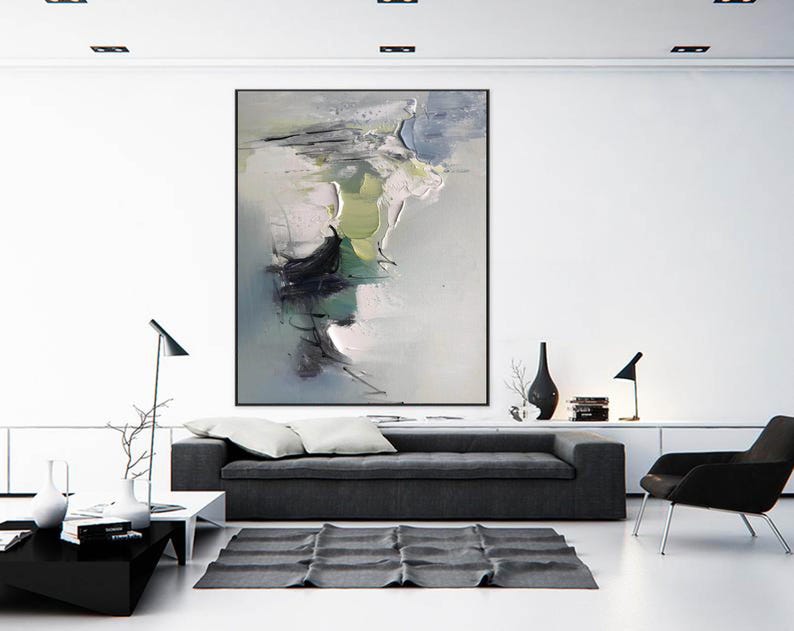 May include: A modern living room interior with a gray sofa, a black chair, and a large abstract painting on the wall. The painting features shades of gray, white, green, and black.