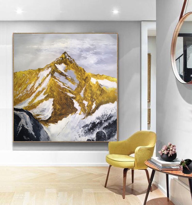May include: Abstract painting of a mountain range with gold, white and black paint. The mountain peaks are covered in snow and the sky is a light blue.
