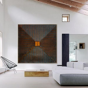 May include: A large abstract wall art piece with a geometric design. The artwork is made of wood and has a dark brown and orange color scheme.