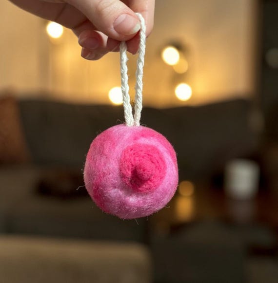 A handmade felt boob ornament ('Booble') — cheeky, niche, and perfect as a white elephant gag gift or a genuine nod to breastfeeding moms.