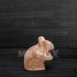 wooden field mouse against black board background side view