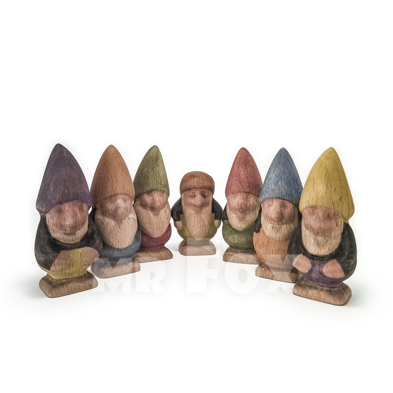 Seven wooden dwarfs. They differ in poses, beard length, hat shape and color. Hat colors are violet, orange, green, brown, red, blue, yellow.