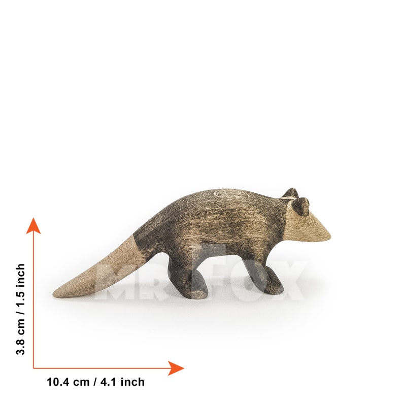 May include: Wooden anteater figurine, 4.1 inches long and 1.5 inches tall. The anteater is primarily brown with a darker, textured pattern on its back and a lighter, natural wood color on its head and tail.