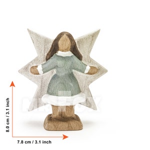 Wooden winter fairy figurine. Front view. White background. Blue dress. White showflake shaped wings. Long dark brown hair.