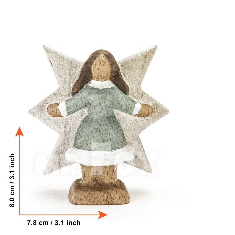 Wooden winter fairy figurine. Front view. White background. Blue dress. White showflake shaped wings. Long dark brown hair.