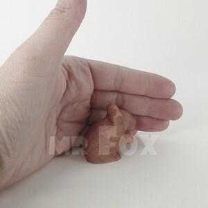 wooden field mouse size reference against woman's hand