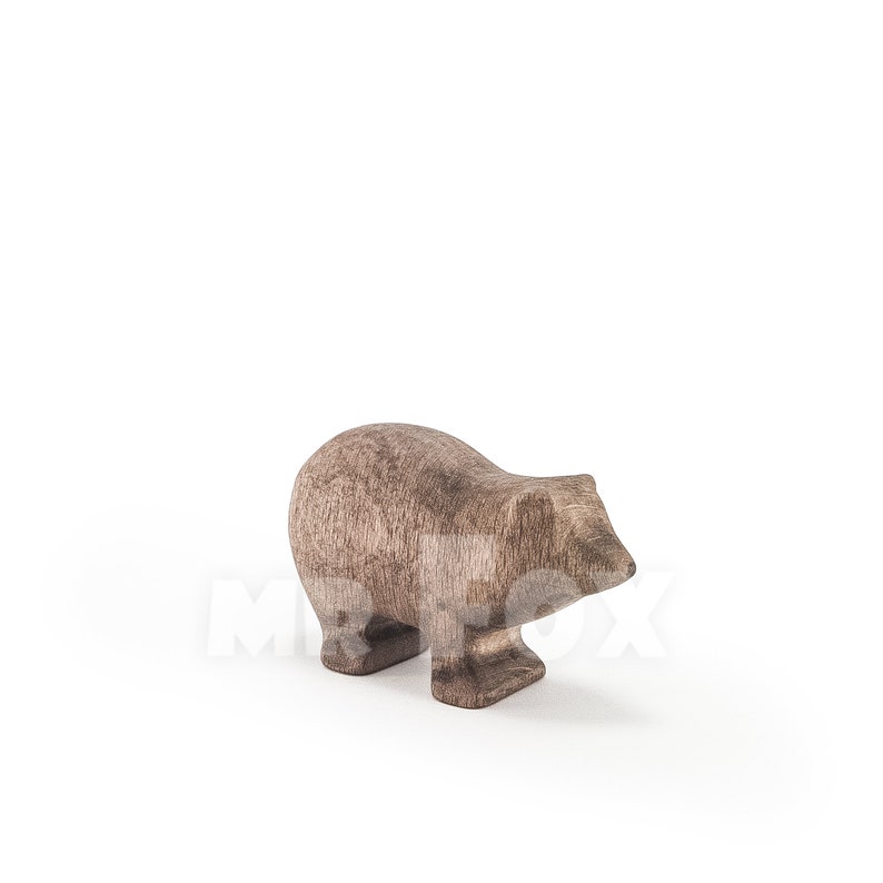 May include: A wooden badger figurine, hand-carved and painted in a dark brown colour. The badger is standing on all fours with its head tilted down.
