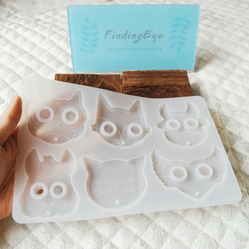 Pu&ograve; includere: Stampo in silicone bianco con sei diversi disegni di volti di animali. Lo stampo presenta un gufo, una volpe, un toro, un coniglio, un gatto e un gufo con le ali.