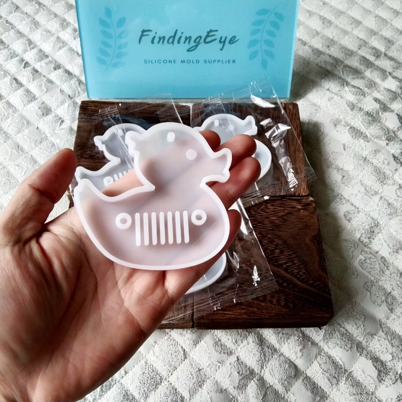 Cute duck keychain and pendant silicone resin mold for DIY gifts and jewelry making. Flexible and durable material for easy release. Use with epoxy resin, UV resin, concrete, plaster, and more. Shop now at https://findingeye.etsy.com