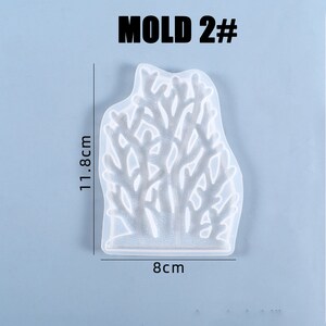 Puede incluir: Molde de silicona transparente con forma de coral, de 11,8 cm de alto y 8 cm de ancho. El molde est&aacute; etiquetado como "MOLD 2#" en negro. Ideal para fundici&oacute;n de resina y manualidades.