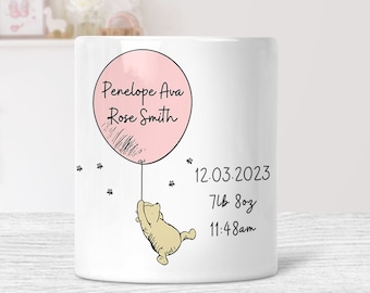 May include: White ceramic mug with a pink balloon illustration. The balloon has the text "Penelope Ava Rose Smith" and a Winnie the Pooh character holding onto the string. The text "12.03.2023 7lb 8oz 11:48am" is printed below the balloon.