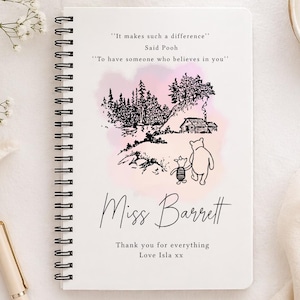 May include: A white spiral-bound notebook with a Winnie the Pooh illustration on the cover. The cover includes the quote "It makes such a difference" and "To have someone who believes in you." The notebook is personalized with the name "Miss Barrett."
