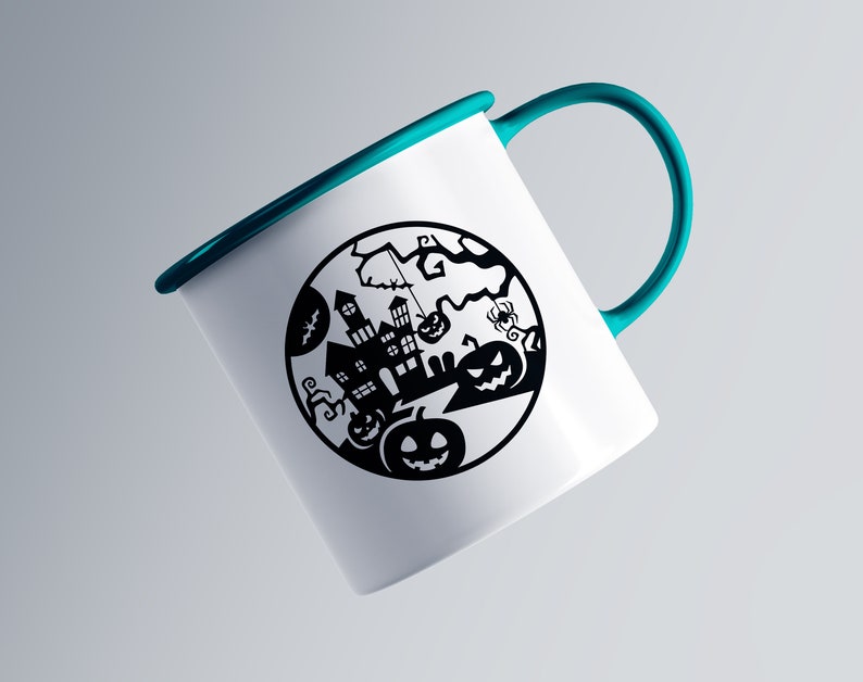 May include: White enamel mug with a teal handle and rim. The mug features a black Halloween-themed design within a circle, including a haunted house, pumpkins, bats, and a spider. The mug is angled slightly, showcasing the design.